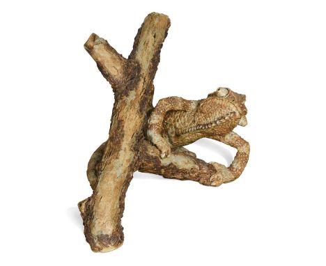 § David Cooke (1970-), a ceramic sculpture of a chameleon on a branch, 1996, impressionistically modelled and glazed in shade