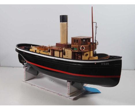 A large handbuilt radio controlled tugboat of wooden and fibreglass/plastic construction, fitted with motor and servos but no