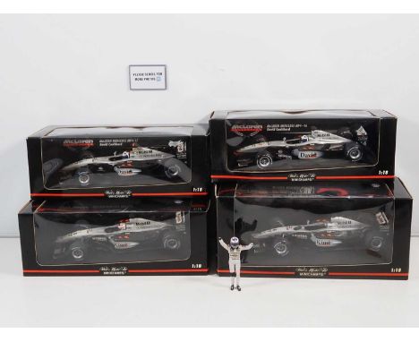 A group of four MINICHAMPS 1:18 scale McLaren Mercedes Formula 1 Cars comprising 2 x K. Raikkonen and 2 x D. Coulthard - G/VG