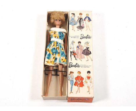 A 1960s MATTEL Barbie doll in original box, stock number 850 with platinum bubble cut hair and blue pearl earrings - G/VG in 