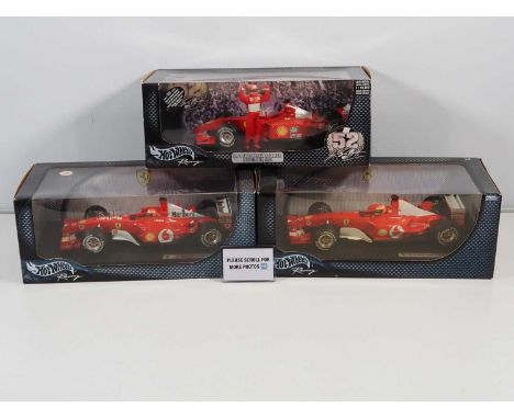 A group of HOTWHEELS 1:18 scale Ferrari Formula 1 cars, all Michael Schumacer examples, 2001 - 2003 cars - G/VG in G boxes, a