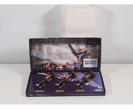 A MINICHAMPS 1:43 scale Formula 1 car limited edition triple pack - Sebastian Vettel, Red Bull Formula 1 World Champion 2010/