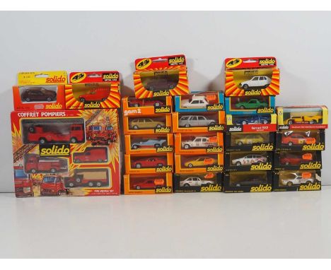 A large group of SOLIDO diecast cars and other vehicles to include a sealed Emergency Vehicles set and several race cars - VG