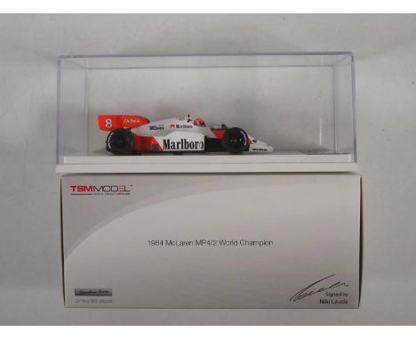 A TSM MODEL 1:43 scale McLaren MP4/2 1984 World Champion, limited edition of 999 signed to the plaque on the base by Niki Lau