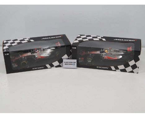 A pair of MINICHAMPS 1:18 scale McLaren Mercedes Formula 1 cars, comprising Lewis Hamilton 2011 and Jenson Button 2012 - VG/E