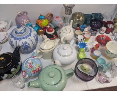 Modern glass and ceramics to include a collection of decorative teapots, tea light holders, egg cups and other itemsLocation: