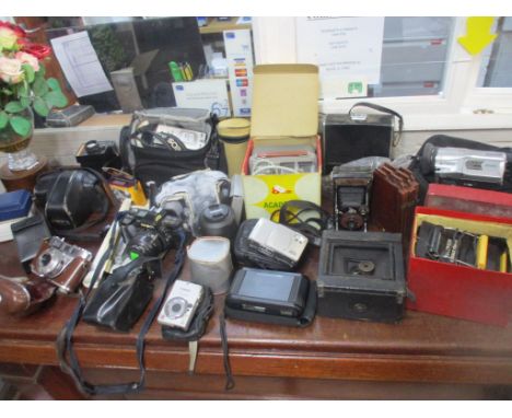 A mixed lot of vintage film and digital cameras and accessories to include a leather cased Kodak Retinette 1B camera, Minolta