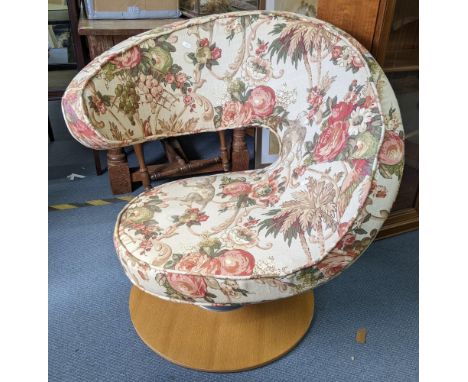 A vintage Peel swivel chair having floral upholstery and on a light wood baseLocation: 