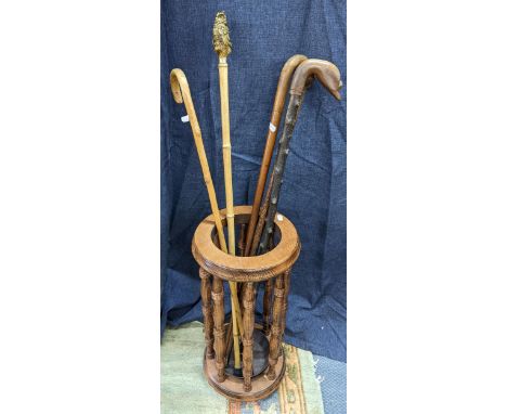 mixed walking sticks and a stick stand to include a bamboo stick having an owl carved handleLocation: 