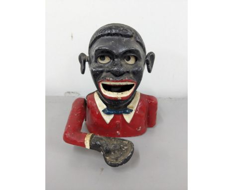 An early 20th century cast metal money box fashioned as an African man Location:These items are listed on the basis they are 