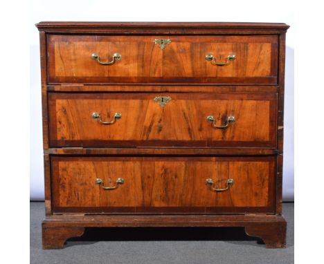 George II walnut chest of drawers, adapted, top with an ogee moulded outline, fitted with three deep drawers, each with bandi