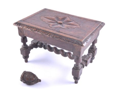 A small oak stool with moulded edge, and stretchers 19cm high, a an item of treen a 7cm carved piece with three vignettes dep