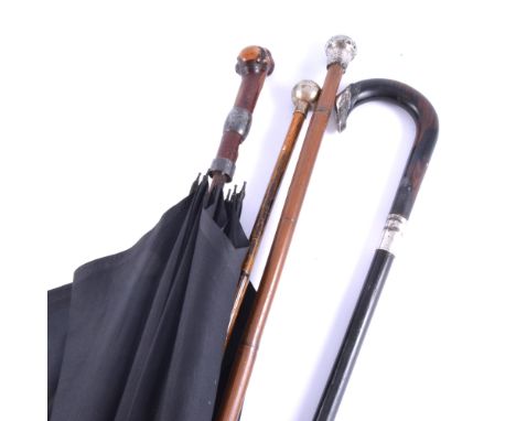 White metal mounted cane, (af); a walking-stick; umbrella; and a swagger stick.