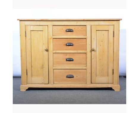 Stripped pine housekeeper's cupboard, fitted with four central drawers, flanked by panelled doors, bracket feet, width 149cm,