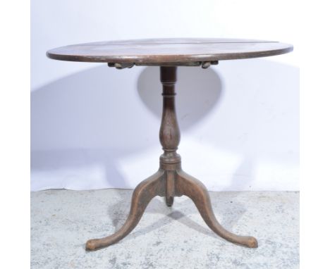 Oak supper table, 19th Century, circular tilt top, turned column, tripod legs, diameter 87cm, height 72cm.