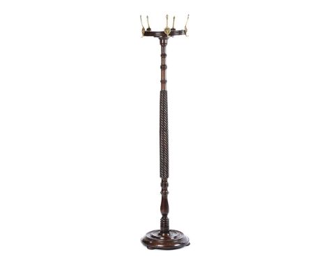 VICTORIAN MAHOGANY COAT STAND WITH BRASS LION MASK HOOKS. RAISED ON A CIRCULAR BASE WITH BUN FEET. HEIGHT: 70 INCHES.DIAMETER