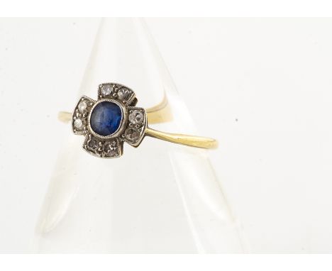 A sapphire and diamond Art Deco ring, the cruciform platinum setting centred with oval sapphire and four pairs of old cut dia