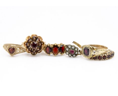 A 19th Century garnet ring, the cushion cut stone within a leaf and scroll mount, ring size T, together with another garnet a