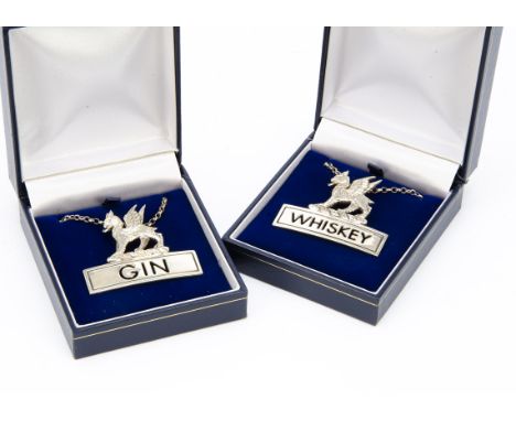 A 1990s pair of silver decanter labels from JHC, one for Gin, the other Whiskey, both with griffins, very good condition, 4cm