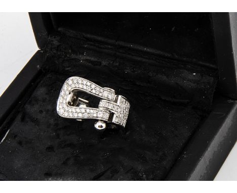 An 18ct gold Fred of Paris buckle ring, diamond encrusted on a plain white gold shank marked Fred, ring size I, approximate d