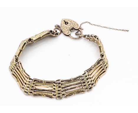 An early 20th Century 9ct gold six bar and textured link gate bracelet, with heart shaped padlock clasp with engraved leaf de