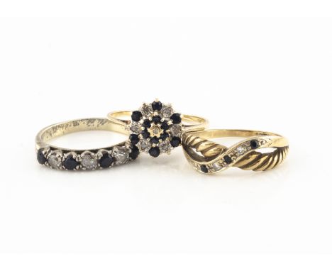 A 9ct gold sapphire and diamond cluster ring, a 9ct gold sapphire and diamond crossover ring and a silver gem set ring, gold 