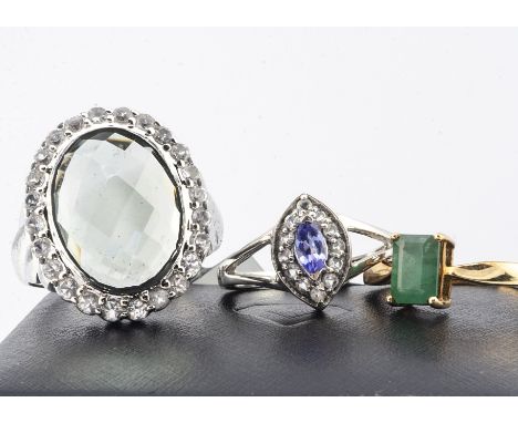 Three contemporary gold and silver gem set rings, including an emerald 9ct gold example, 1.8g, ring size N 1/2, a silver 'gre