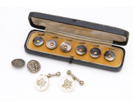 A cased set of mother of pearl and gold buttons, in a green leather case by Terry &amp; Company, together with a pair of moth