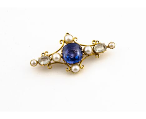 A gold synthetic sapphire and seed pearl bar brooch, the central blue claw set sapphire in a cruciform setting with half cut 