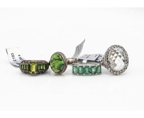 Four contemporary gem set silver dress rings, comprising a 'green amethyst' with topaz, ring size N, a five stone emerald rin