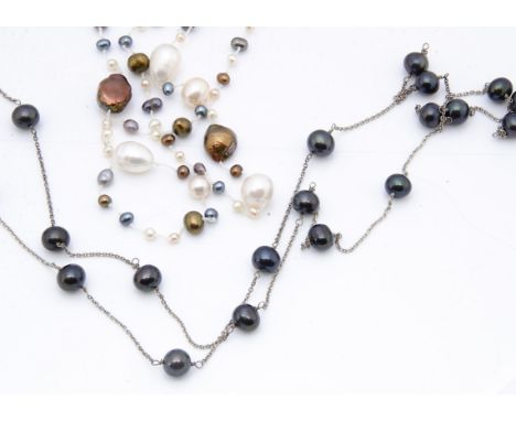 An opera length freshwater cultured pearl necklace, of various baroque, black, silver and white pearls all on a knotted strun