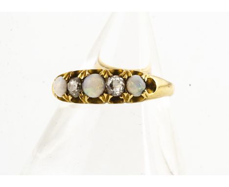 An 18ct gold opal and diamond five stone dress ring, the three cabochon white precious opals alternately set with two old cut