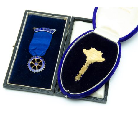 A 1930s 9ct gold presentation key, in a fitted Payne box, with inscription, 13.8g, together with a silver gilt and enamelled 