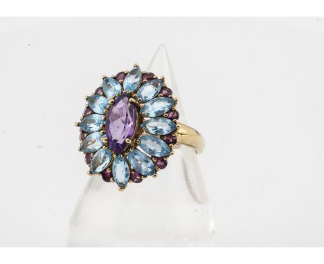 A topaz and amethyst 9ct gold dress ring, the oval setting with navette shaped marquise mixed cut amethyst with a bezel of bl