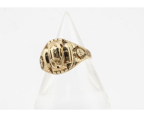 An American college ring, the yellow metal with cast decoration of an eagle upon a plinth with signs of enamelling with monog