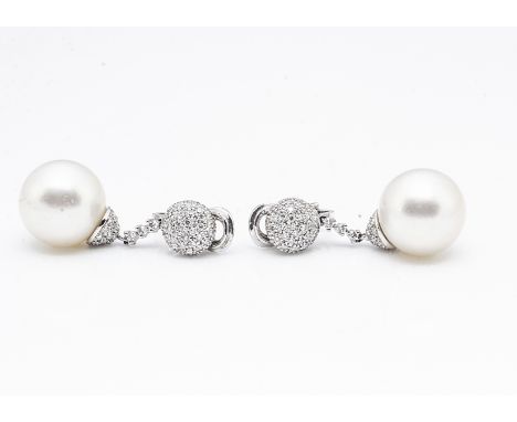 A pair of 18ct gold diamond and cultured pearl drop clip earrings, the large white pearls supported on diamond encrusted moun