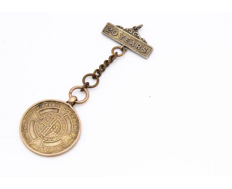 A 9ct gold GWR 15 year First Aid and Efficiency medal, 2.5cm diameter, 5.8g on base metal chain with white metal 20 year serv