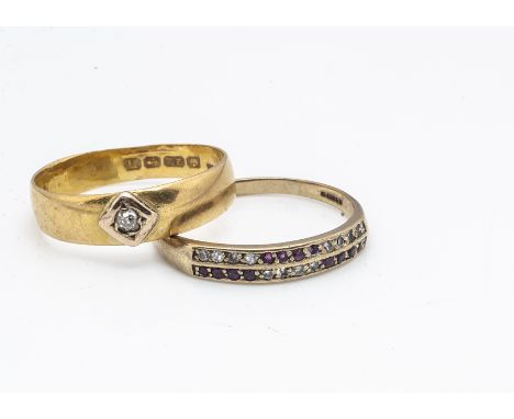 A 22ct gold diamond set wedding band, ring size Z, 4.9g and a 9ct gold ruby and eight cut diamond half hoop eternity, ring si
