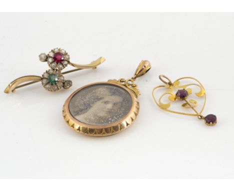 An Edwardian gold double sided circular open locket, with egg and dart decoration, together with three Art Nouveau and Edward