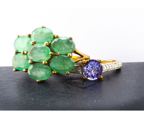 Two contemporary gem set gold rings, comprising a tanzanite and diamond dress ring, the circular mixed cut tanzanite in claw 