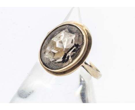 A 9ct gold smoky quartz dress ring, the mixed cut in collet setting, ring size H, 4.1g 