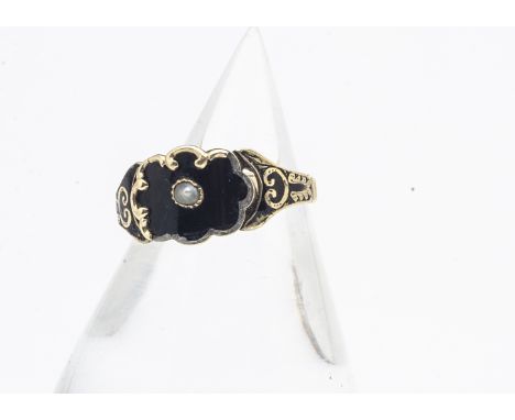 A 19th Century gold and enamel pearl set mourning ring, of shaped central panel with enamel and gold bracket shoulders on a s