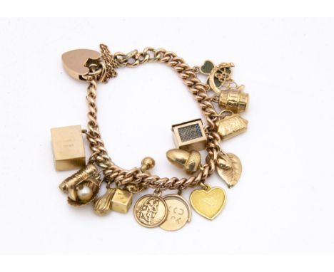 A 9ct gold charm bracelet, with a collection of various 9ct gold charms including a shell and pearl, a 10 bob note, miniature