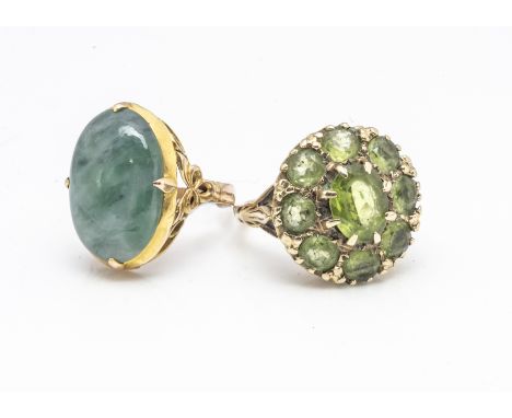 A Chinese oval jade and gold signet ring, with scrollwork decoration, ring size L, 4.3g together with a 9ct gold peridot clus