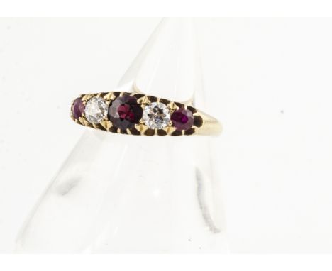 An 18ct gold ruby and diamond five stone ring, the three circular cut rubies with two old cut diamonds all in 18ct gold claws