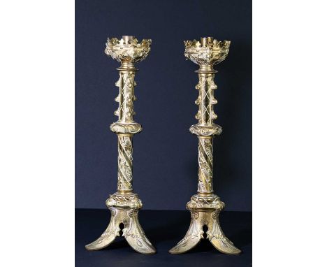A pair of decorative brass altar style candlesticks with relief decoration, height 43cm.Condition Report: Tarnishing, wear an