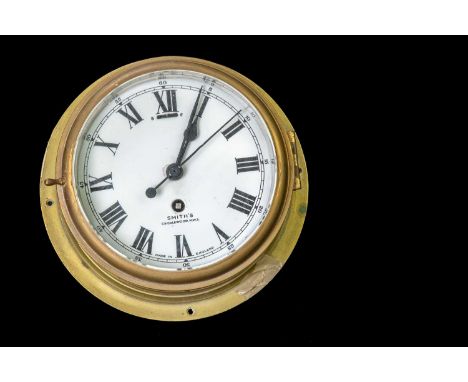 SMITHS; a brass cased ships' clock, the enamelled dial set with Arabic and Roman numerals and signed 'Cricklewood N.W.2', dia