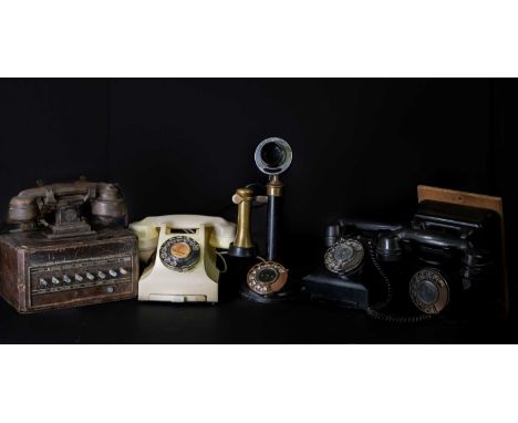 A collection of assorted vintage telephones to include a black metal painted candlestick example, height 33cm, three bakelite