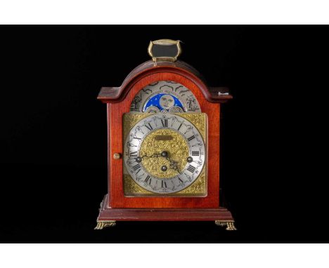HERMLE; a reproduction mahogany effect bracket clock, the silvered and brass coloured face set with moon phase mechanism and 