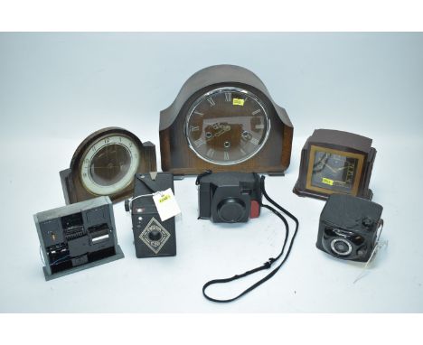 Three mid 20th Century mantel clocks, including: a Smiths bakelite clock; an Ensign E20 camera; a Robi camera; and other item